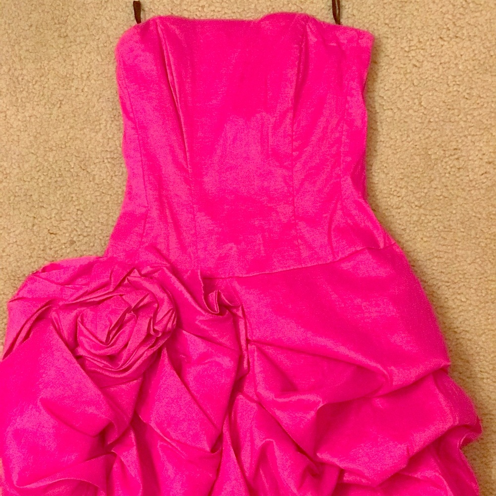 Pink dress with ruffled detailing.